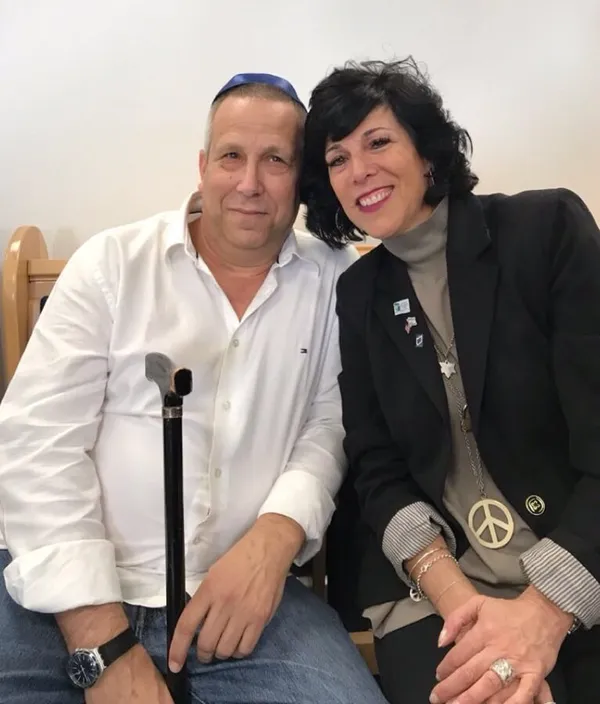 A happy couple sitting closely together indoors.