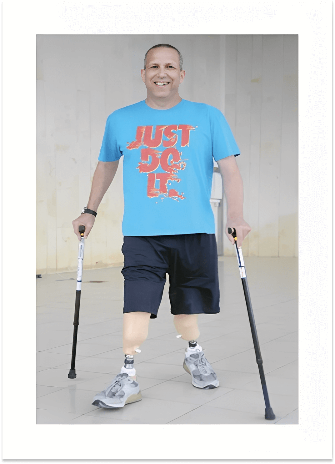 Man with prosthetics using crutches indoors
